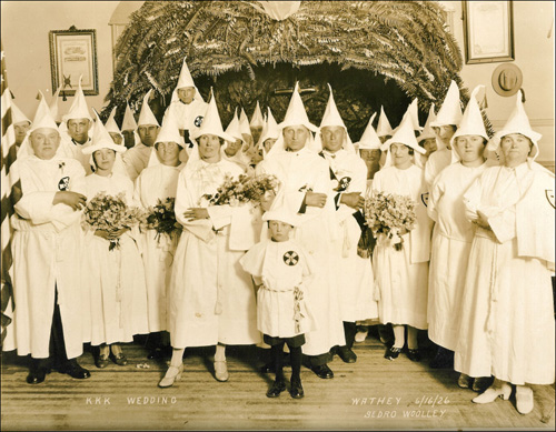 KKK wedding with everyone in pointed cap and Klan robe garb. Writing on photo says it was June 1926 in Sedro Woolley