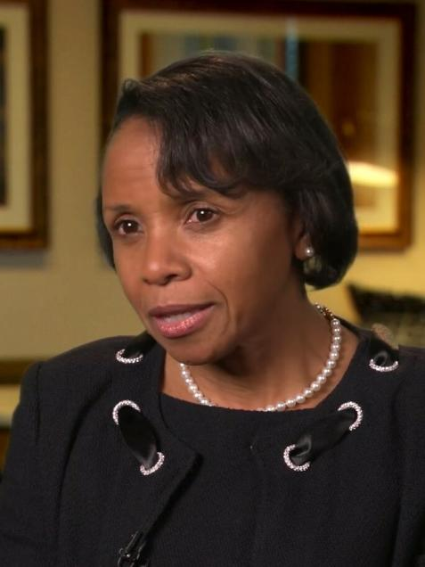 middle aged black woman with short dark hair wearing a black dress and white pear necklace, Judge Wilhelmina Wright