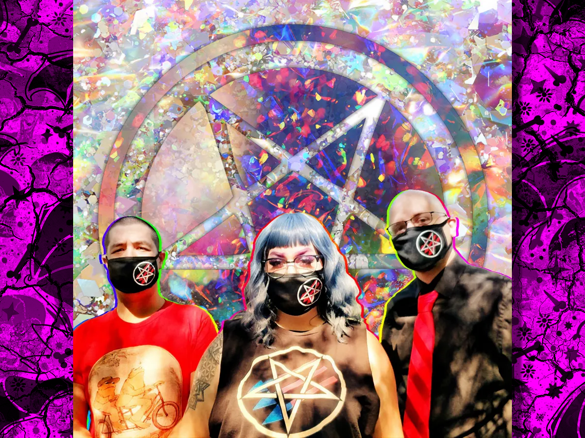Three people stand beside each other, each wearing black masks with a pentagram and three arrows logo. The background behind them is psychedelic.