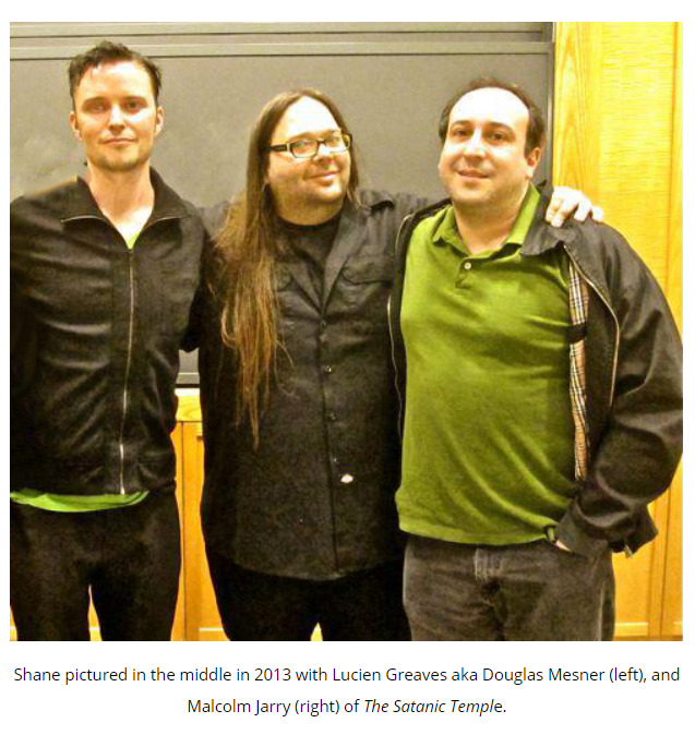 image of three people standing together. Shane pictured in the middle in 2013 with Lucien Greaves aka Douglas Mesner (left), and Malcolm Jarry (right) of The Satanic Temple.