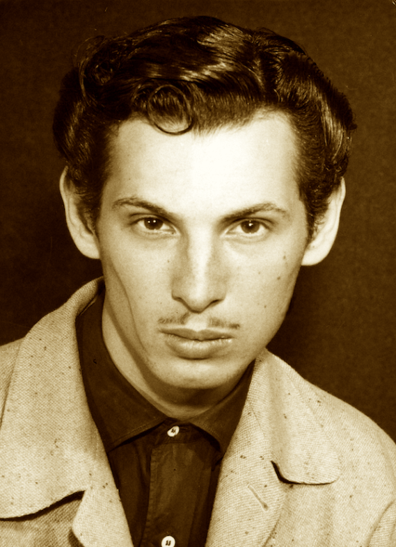 sepia toned photo of Anton LaVey as a young man: thin white dude with a full head of hair and front curl and pencil thin mustache